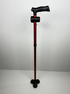 Full-length red walking cane with a TrackMount tracker holder attached near the handle