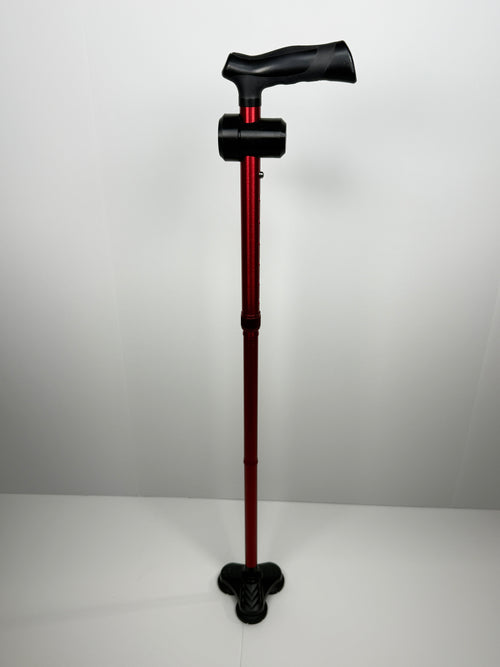 Full-length red walking cane with a TrackMount tracker holder attached near the handle