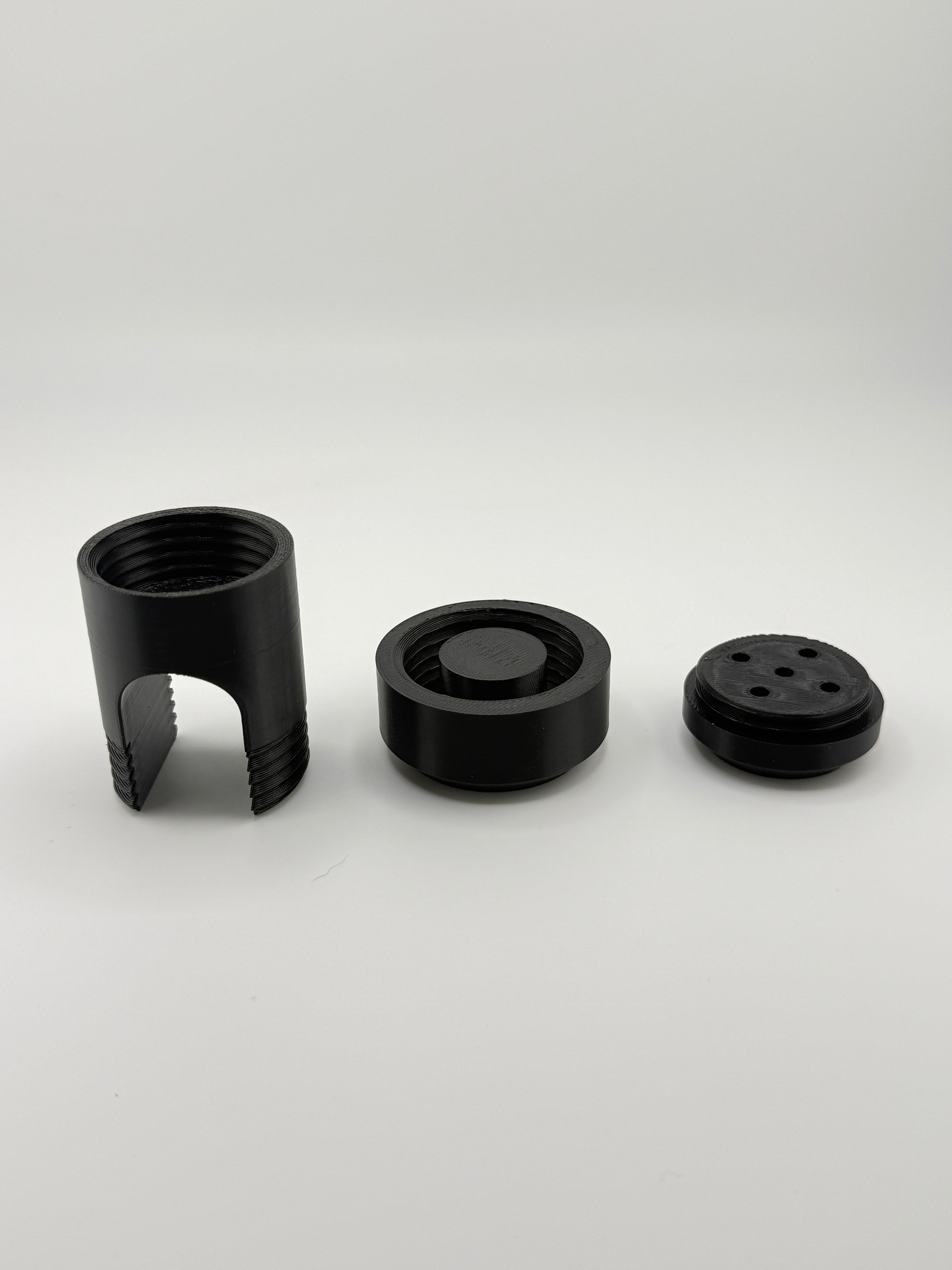 TrackMount three-piece kit: perforated cap, main body, and main cap in black PETG