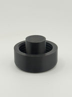 Single black TrackMount extended cap with the tall protruding stop rib used for securing to thinner white canes