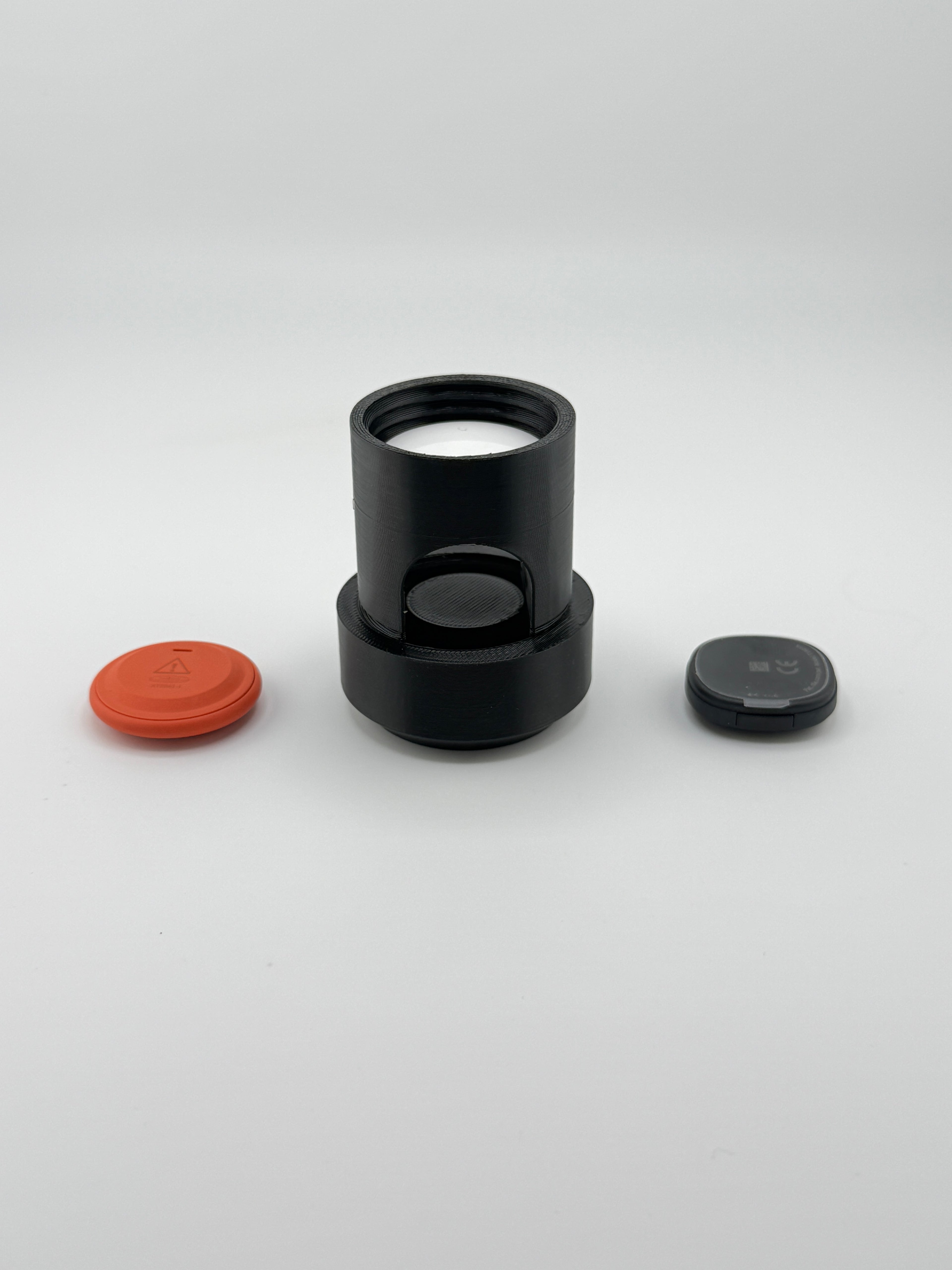AirTag seated inside the TrackMount tracker compartment with Moto Tag and Tile Sticker alongside
