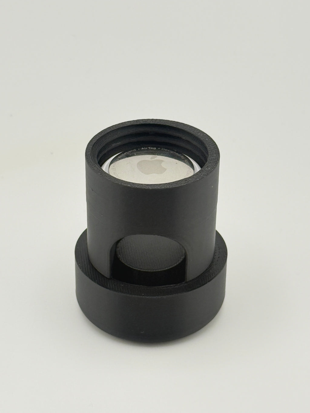 TrackMount body standing upright with an Apple AirTag resting inside the open tracker compartment