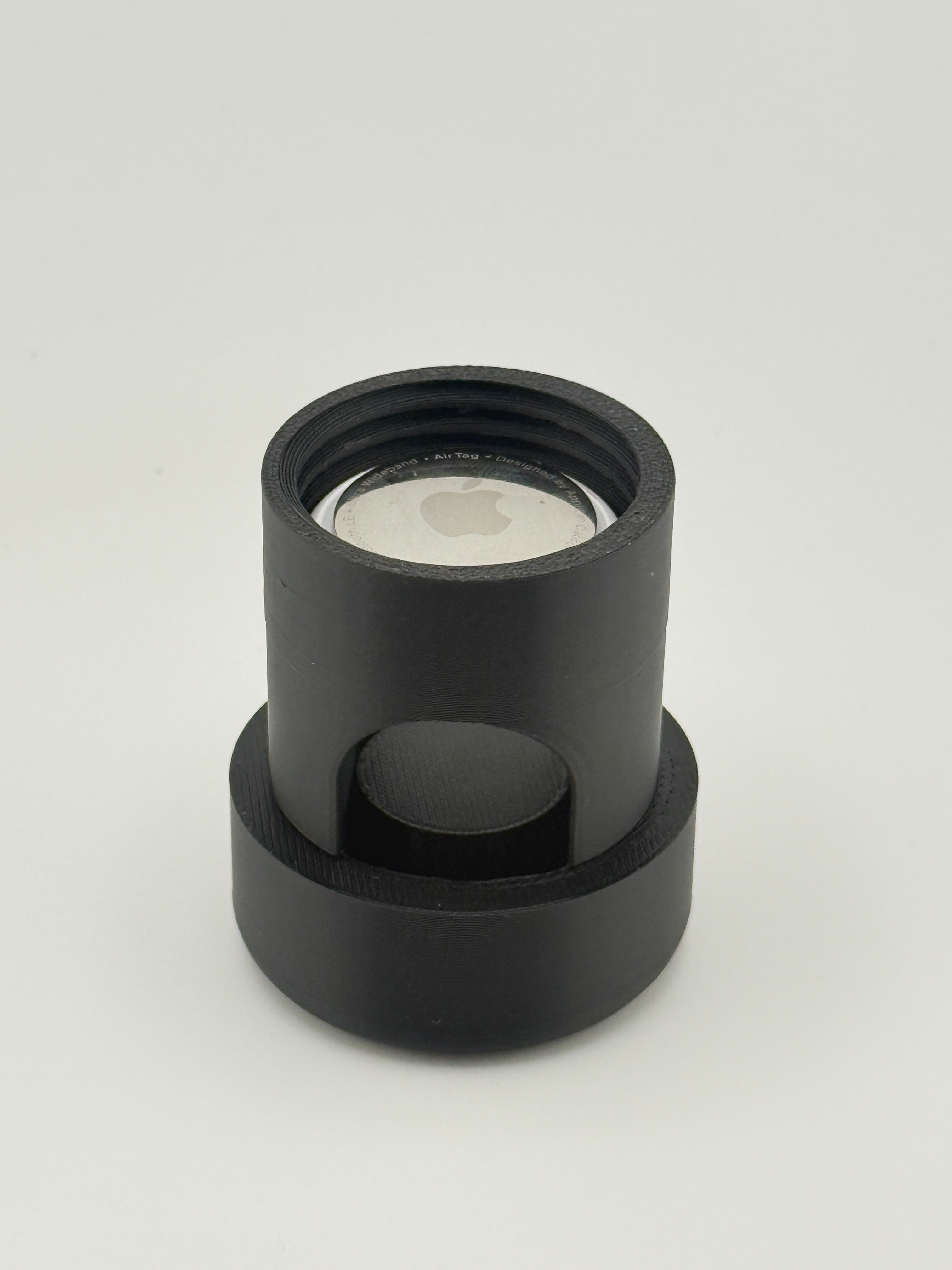 TrackMount body standing upright with an Apple AirTag resting inside the open tracker compartment