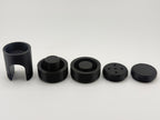 All five black TrackMount parts in a row: main body, two clamping caps, perforated cap, and solid cap