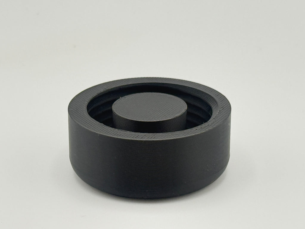 Single black TrackMount main cap shown from above, with internal threads and the central stop rib that grips the cane