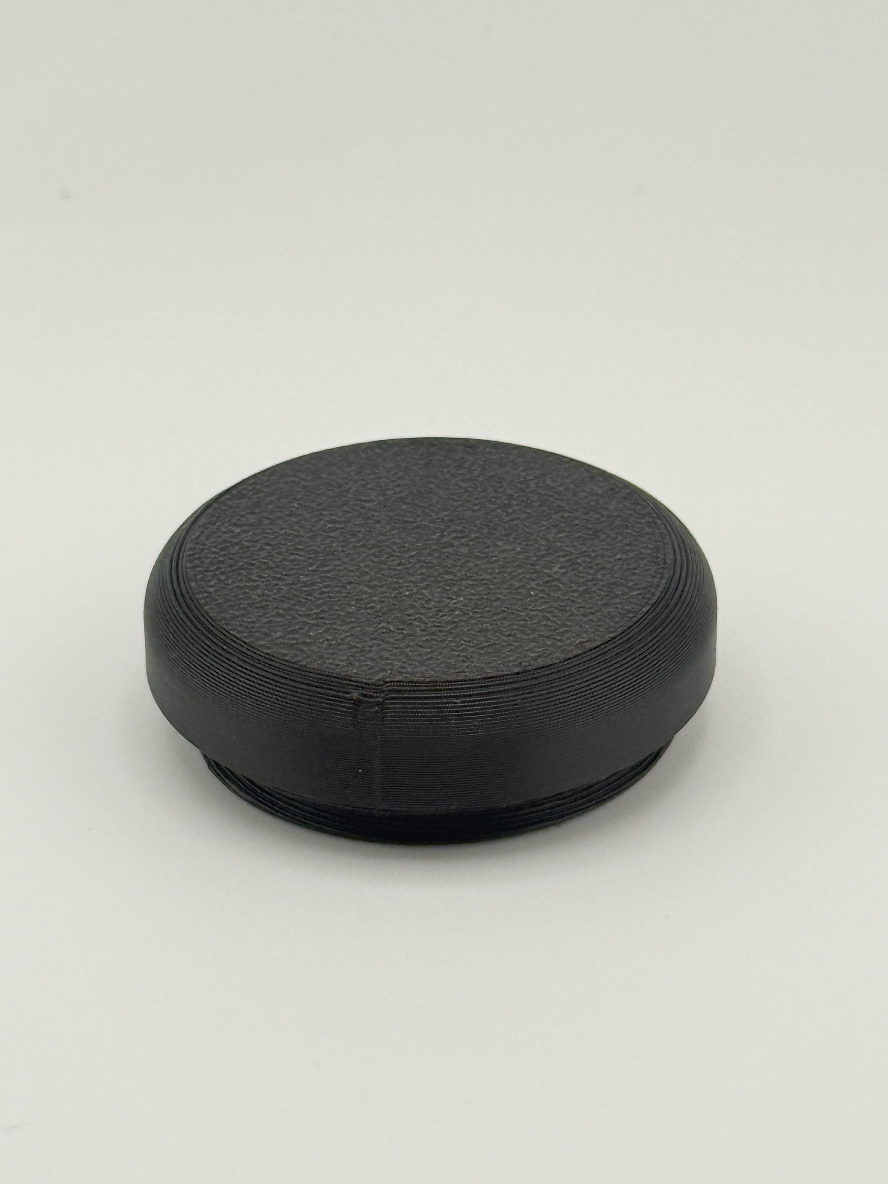 Black solid TrackMount tracker cap with a smooth sealed top for extra protection from moisture and debris