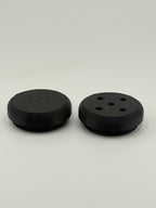 Two TrackMount tracker caps: a solid cap for weather protection and a perforated cap that lets the tracker chime through