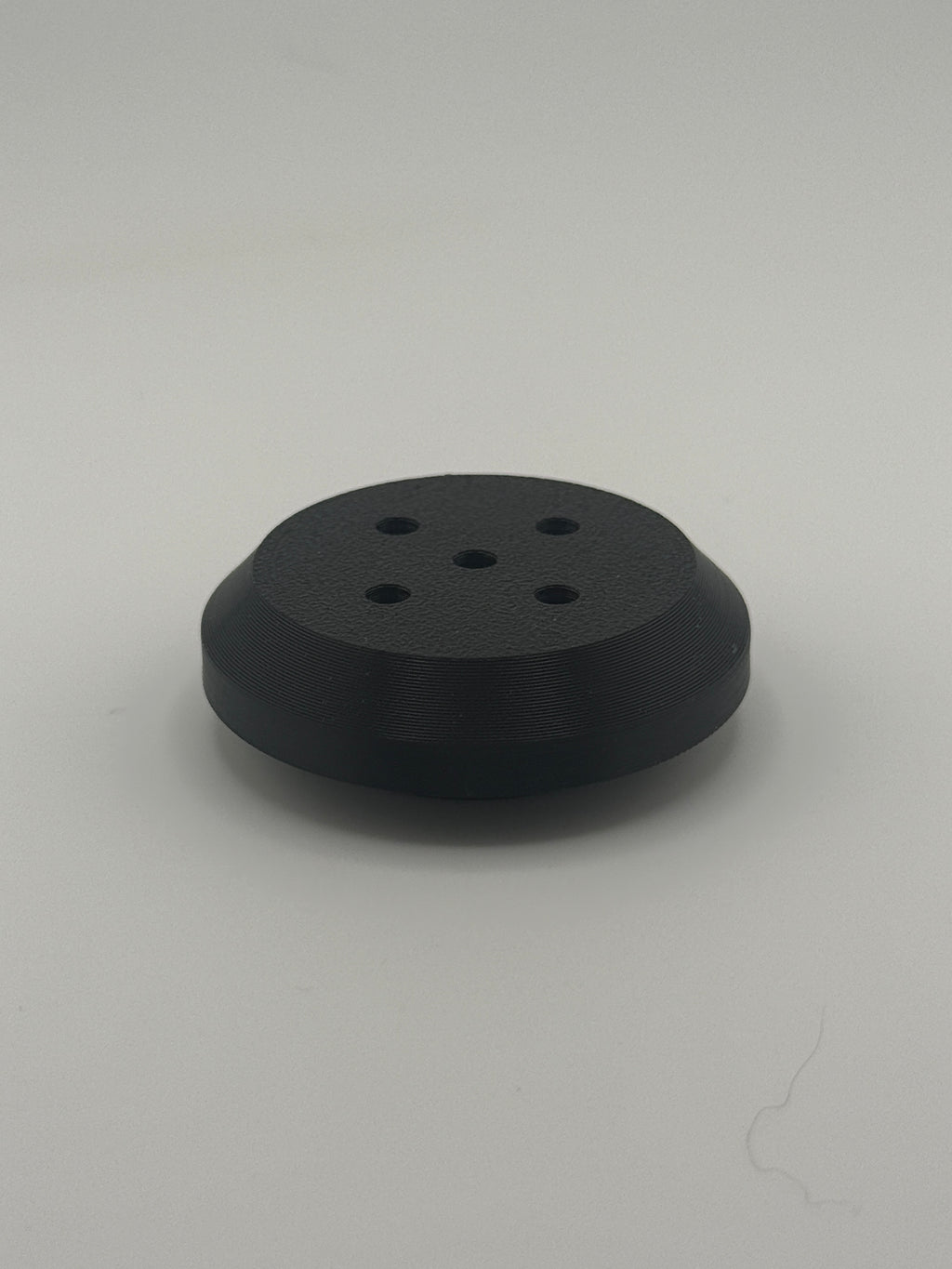TrackMount XL perforated cap with five holes that let a tracker chime ring through