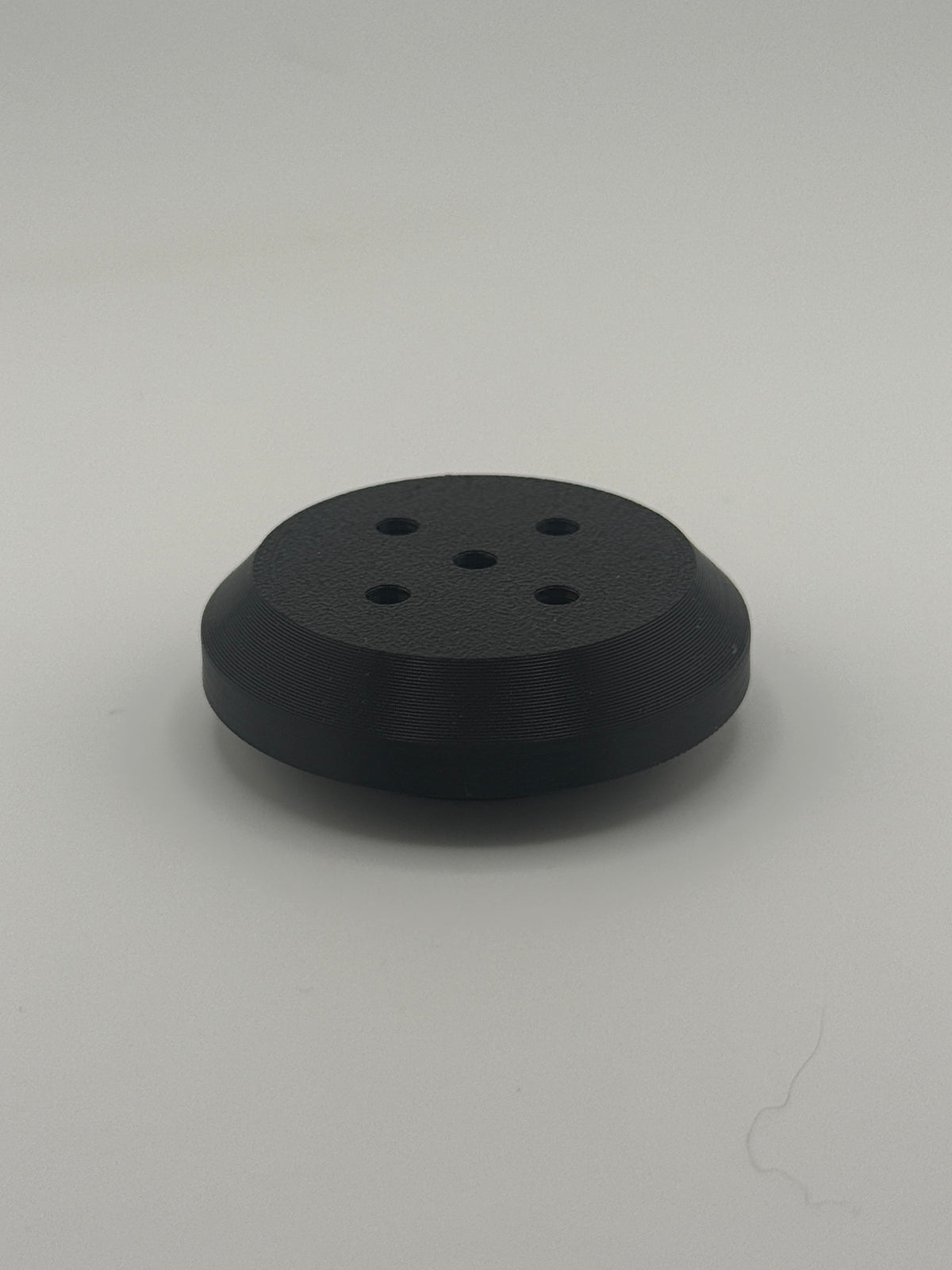 TrackMount XL perforated cap with five holes that let a tracker chime ring through